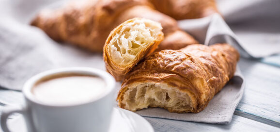 Eine Kaffee-Tasse und Croissants